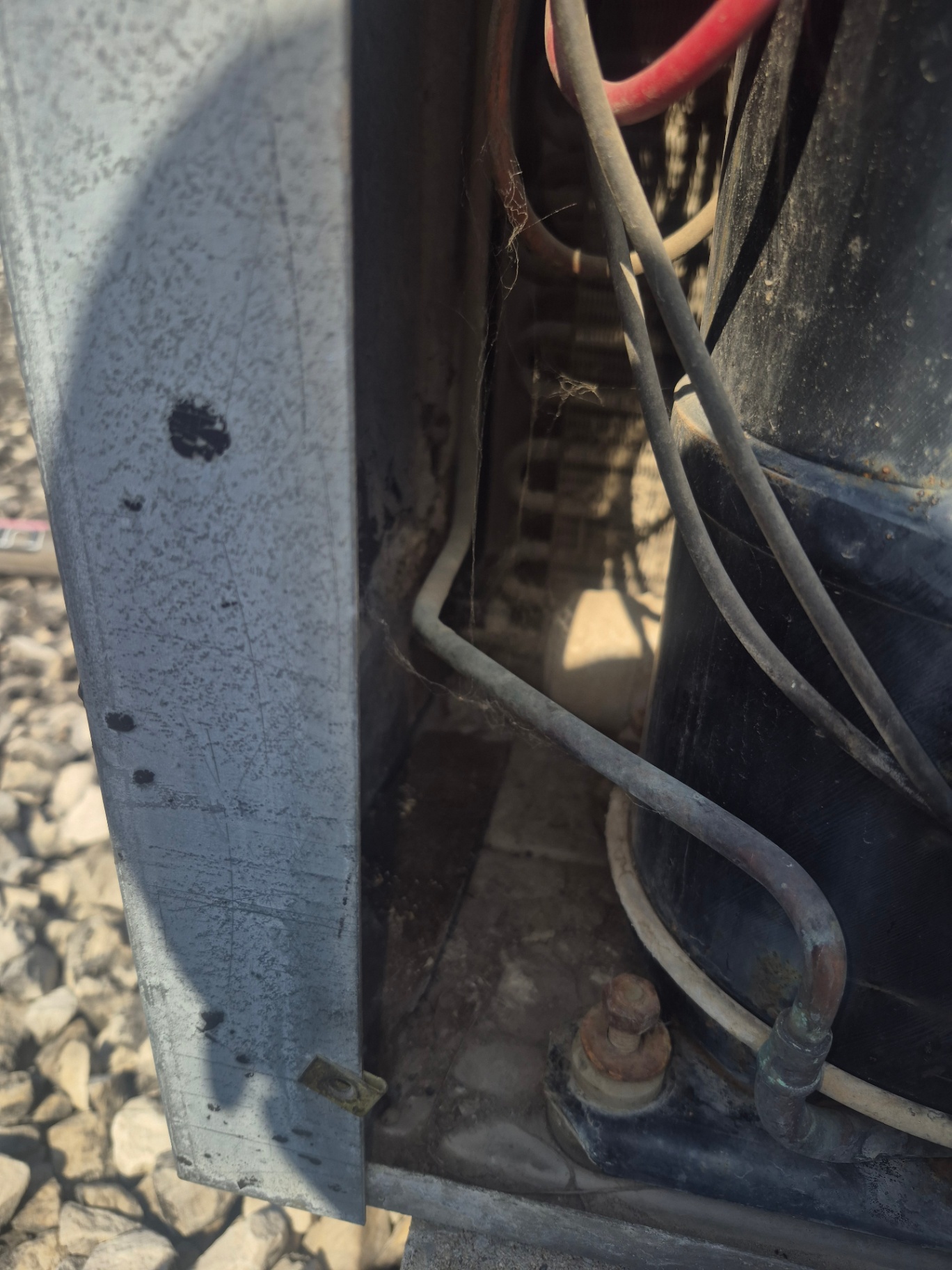 Refrigerant service ports on a commercial rooftop HVAC unit during a deep vacuum to remove moisture and non-condensables