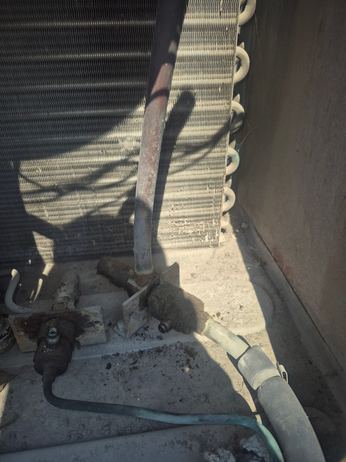 Repaired copper refrigerant piping on a commercial rooftop HVAC unit after brazing