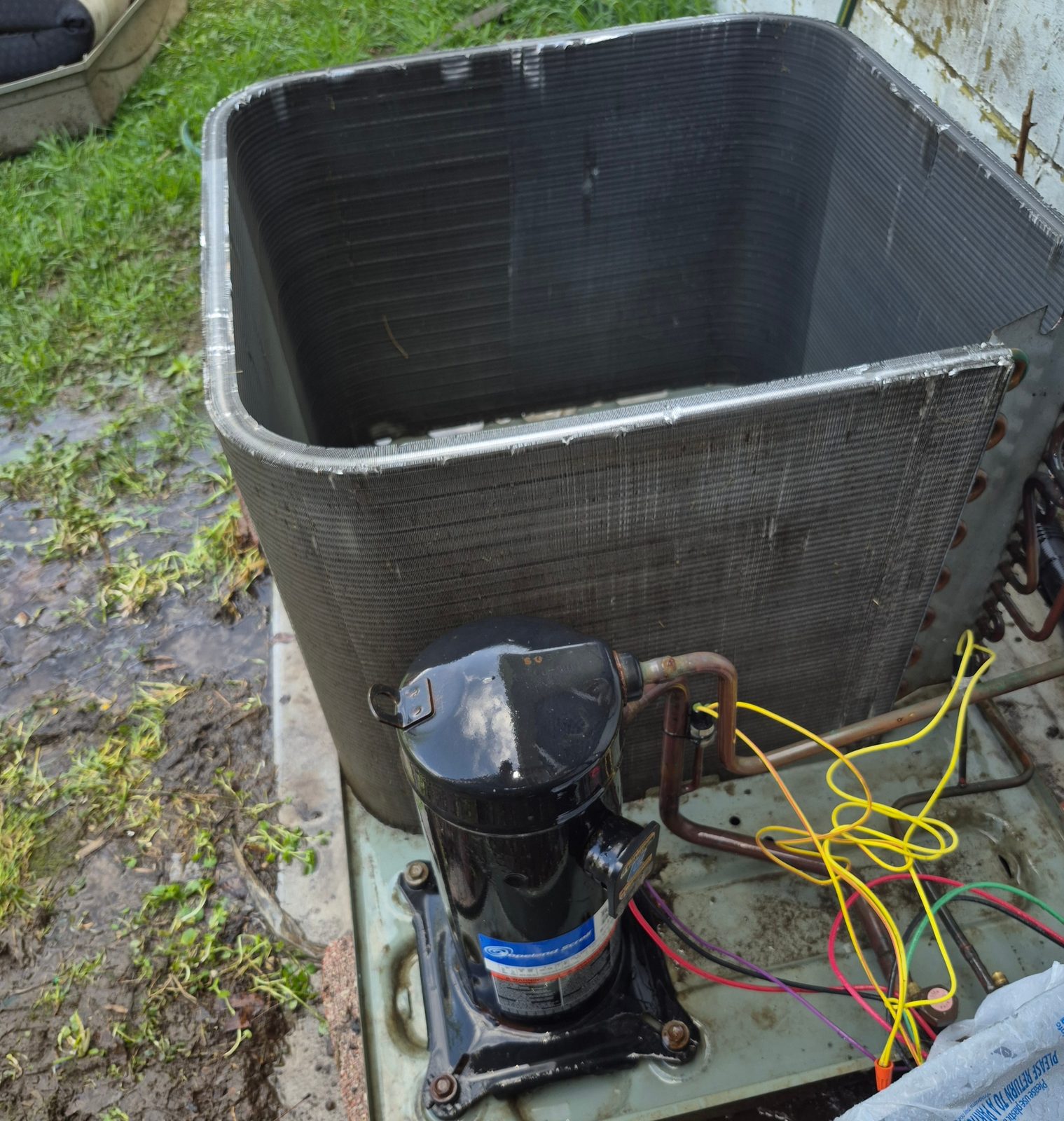 Same condenser unit after deep cleaning with clean compressor and clear coil fins